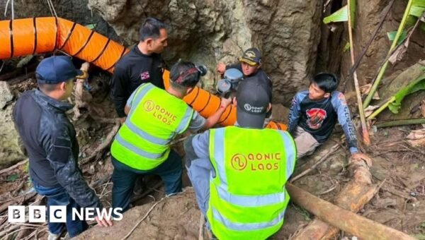 Rescuers race to free seven people trapped in flooded Laos cave