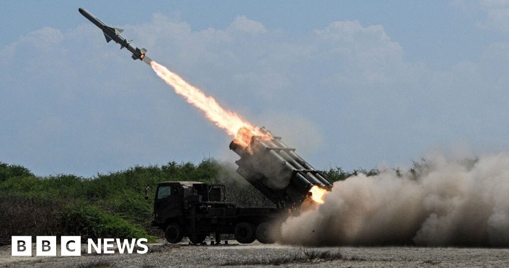 Japan defence minister denies militarism, criticises China's 'huge arsenal'