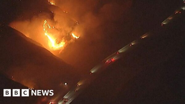 Watch: California wildfires rage near passing vehicles