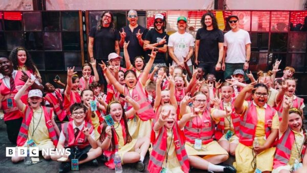 Pupils perform for Foo Fighters in stadium show