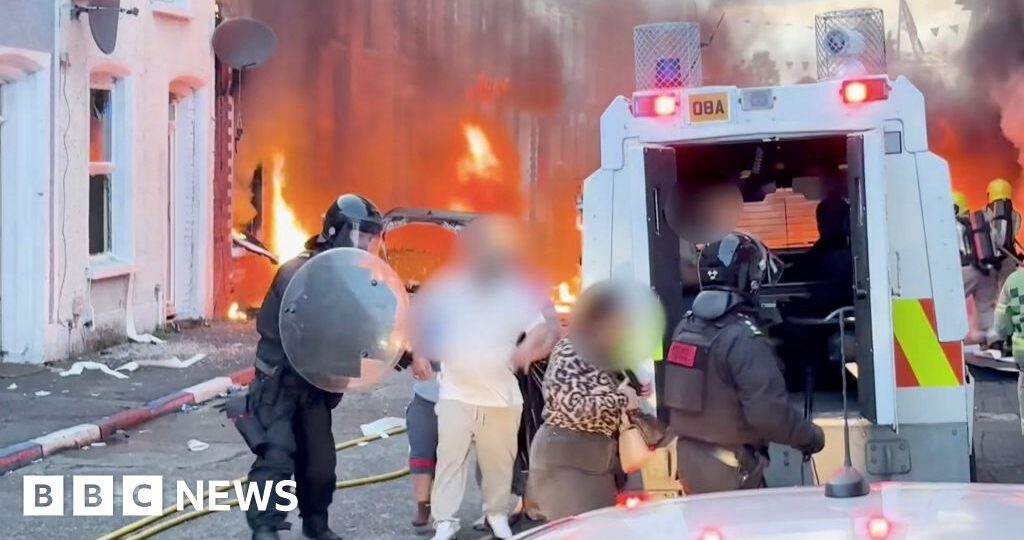 Watch: Residents flee as cars and houses burn in Belfast