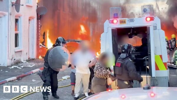 Watch: Residents flee as cars and houses burn in Belfast