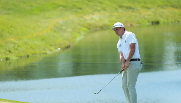 J.T. Poston handles the wind at Memorial for low round of tournament and the lead