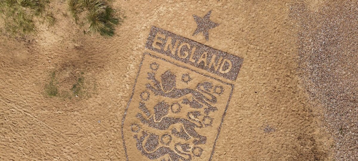 Artist creates 30-foot England badge on Suffolk beach ahead of World Cup clash