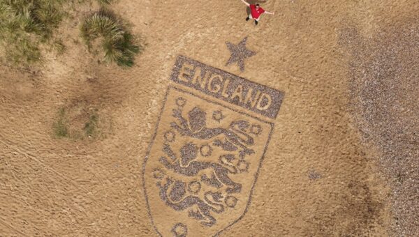 Artist creates 30-foot England badge on Suffolk beach ahead of World Cup clash