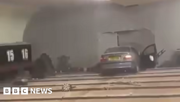 Man charged after car crashes through bowling alley