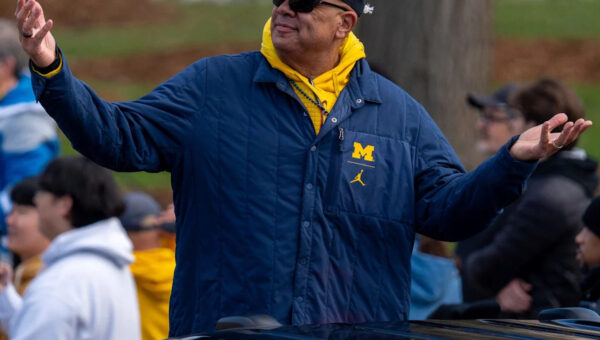 Why has Michigan kept AD Warde Manuel through all the scandals?