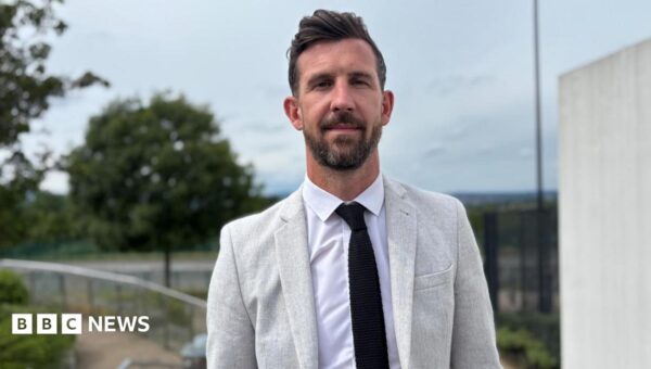 Football star swaps dressing room for classroom