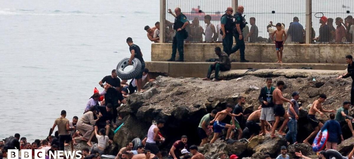 Hundreds of migrants swim from Morocco to Spanish enclave of Ceuta