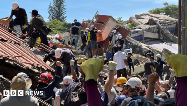 Anguish of Colombian brother at rubble of building being searched for earthquake survivors