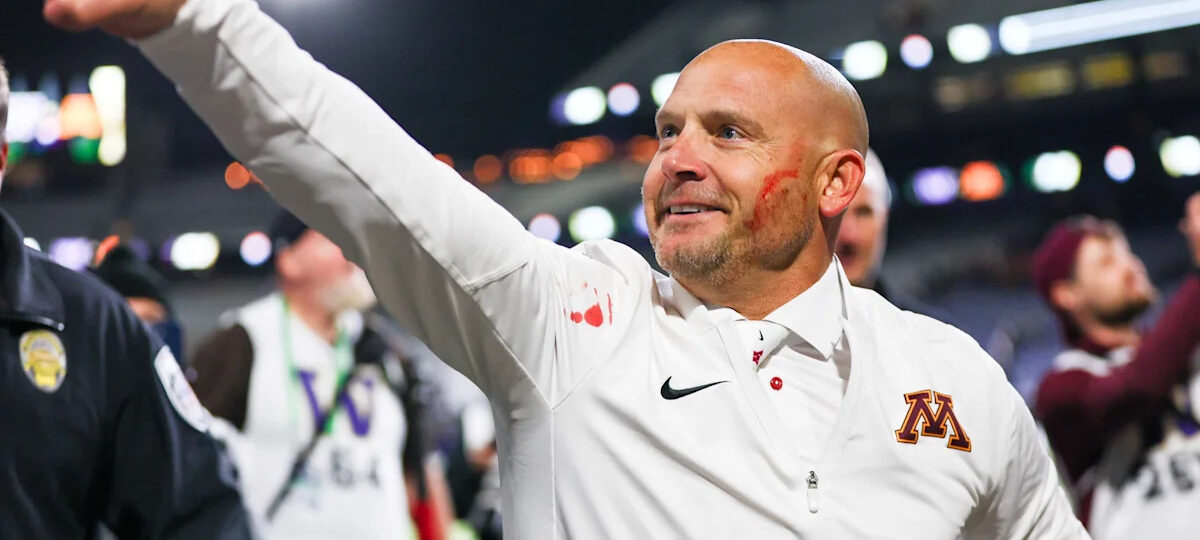 Minnesota coach P.J. Fleck wipes player's blood on his own cheek while celebrating 27-24 win over Washington