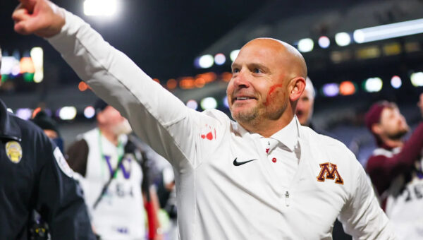 Minnesota coach P.J. Fleck wipes player's blood on his own cheek while celebrating 27-24 win over Washington