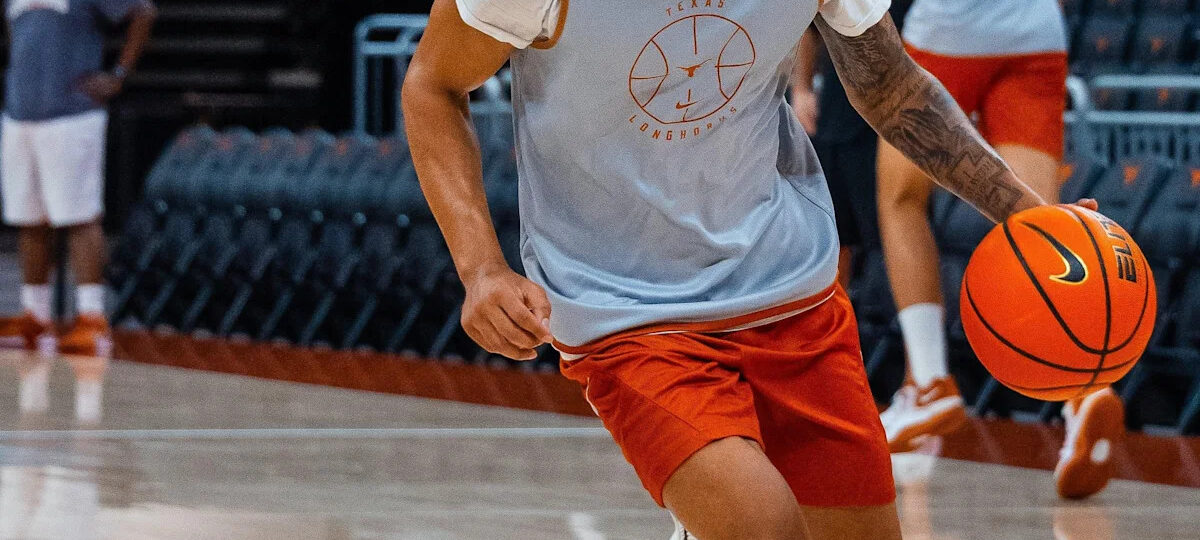 Texas G Mikey Lewis fractured his foot in practice