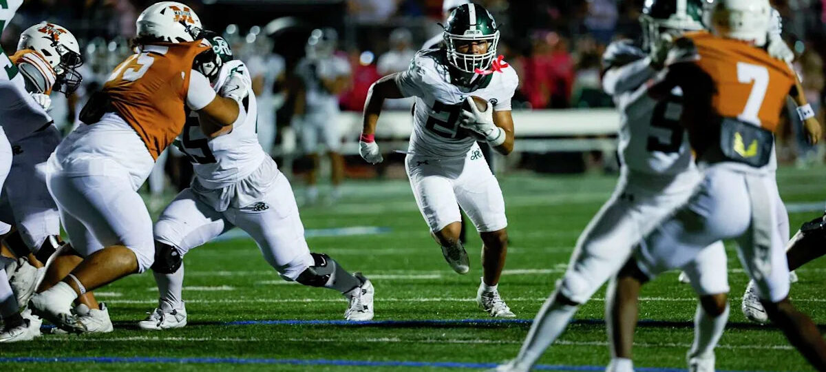 Running back Ayden Fernandez carries red hot Reagan to win against Madison