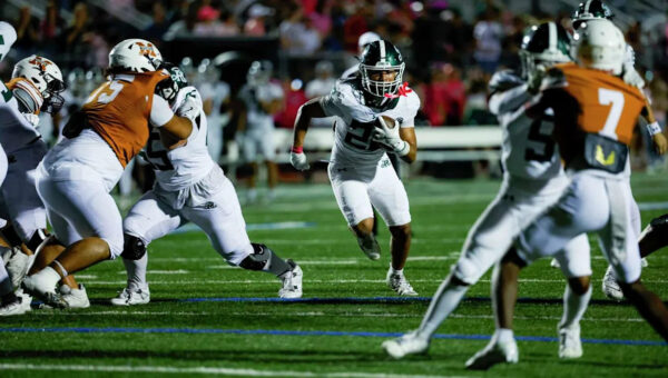 Running back Ayden Fernandez carries red hot Reagan to win against Madison