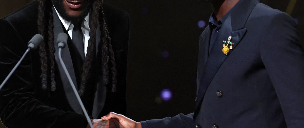 Burna Boy Suits Up to Present Bukayo Saka With the Socrates Award at the 2026 Ballon d’Or