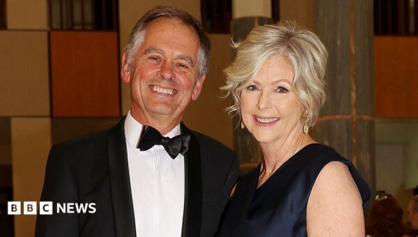 Australian MP loses both legs after alleged car attack, husband says