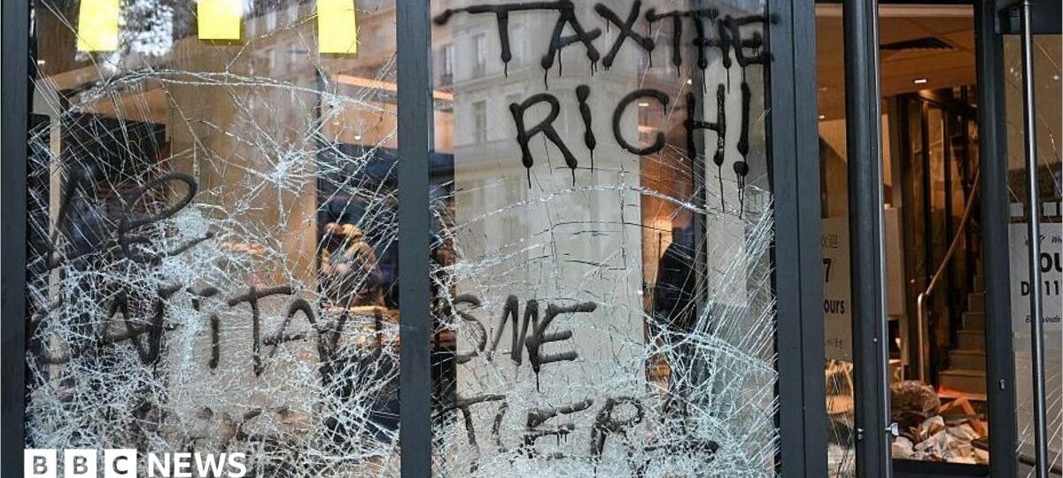 Burnt out cars and shattered glass on Paris streets after protests turn to riots and looting