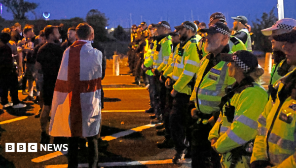 Protesters scuffle with police as migrants brought ashore on south coast